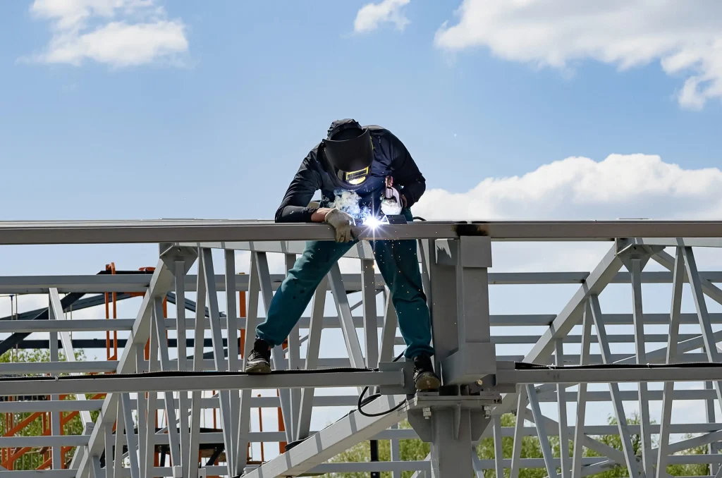 2026 08 10T16 19 03.296189Z man welds at the factory on a wonderful day free photo 1