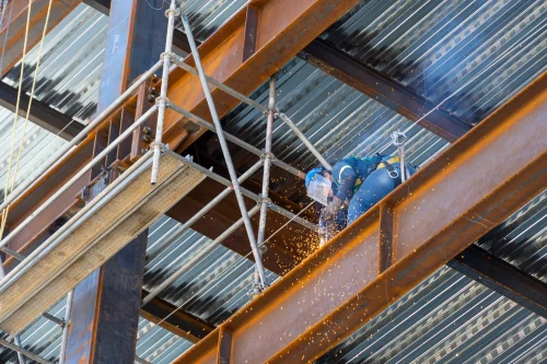 2026 08 10T16 26 33.925124Z rusted steel structure while a man is welding joints mexico guadalajara photo 1