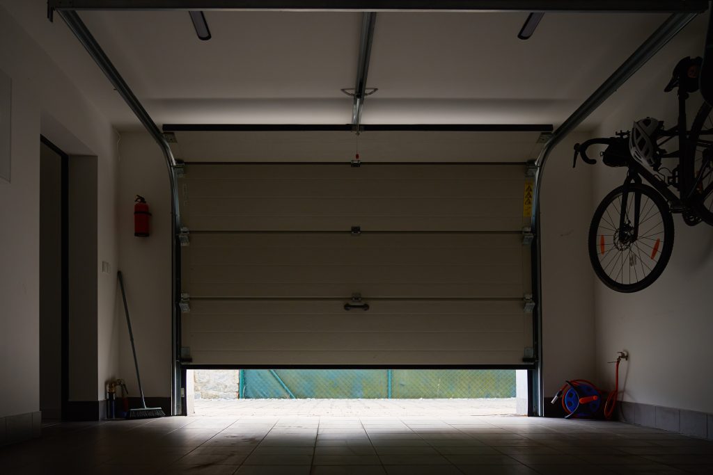 canetto welding fab sylvania ga 2026 08 10T20 23 30.328501Z interior view of residential garage with partially open sectional door ceiling rails and bicycle photo